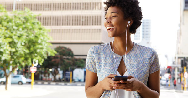 An individual is preparing to contact someone, focused and holding a device.